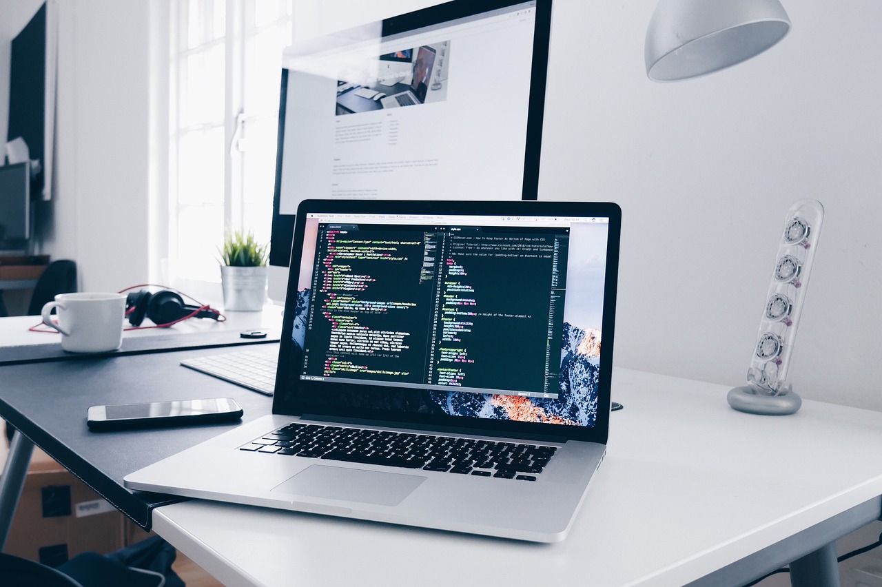 A team of software developers meeting around a laptop