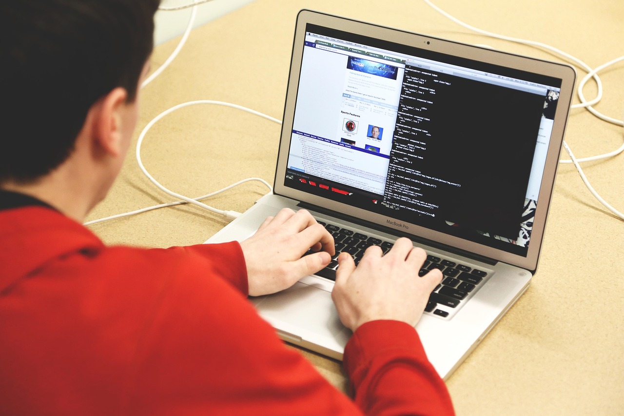 Developer working alongside an AI coding assistant on a laptop