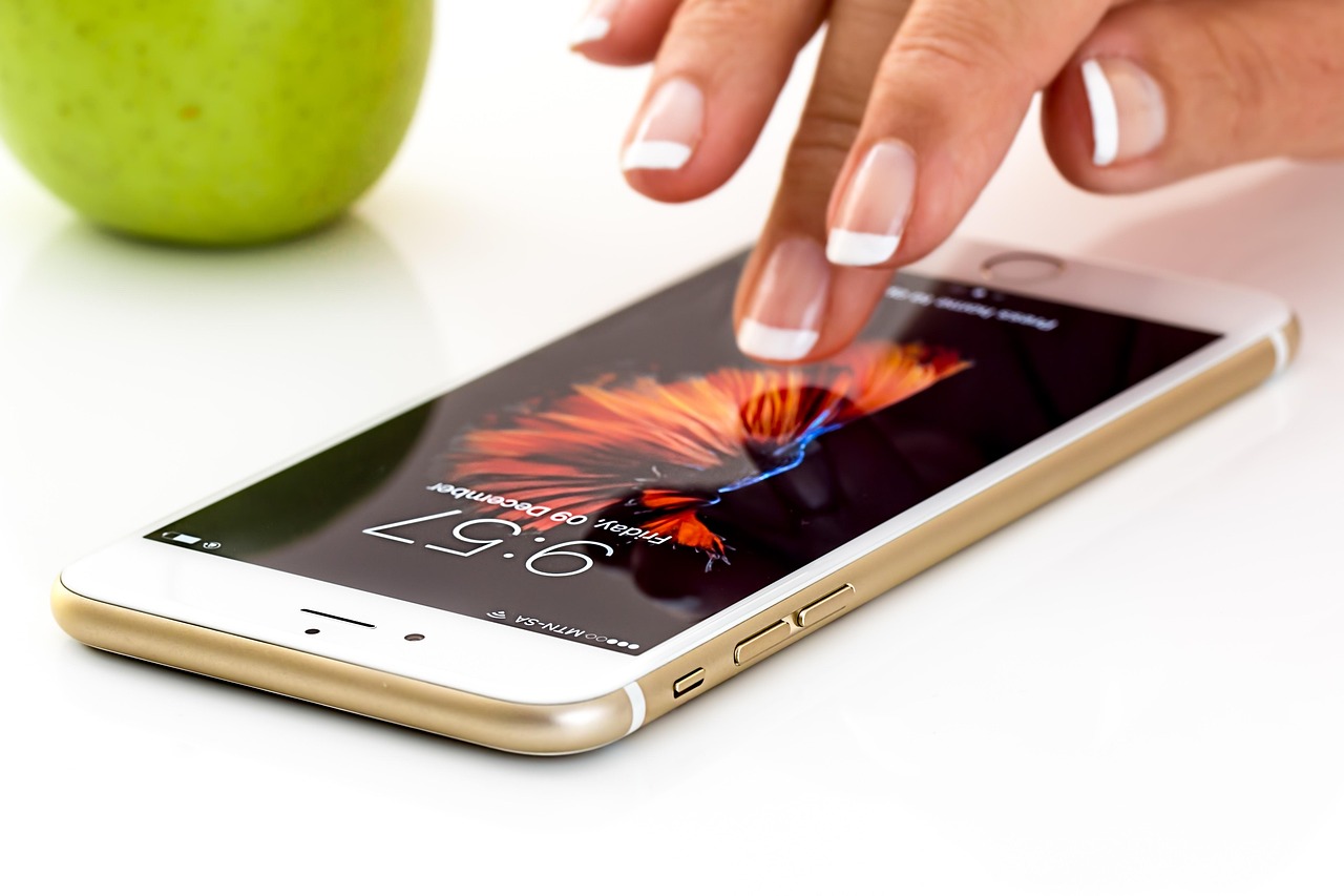 Person holding a phone testing a mobile app outdoors