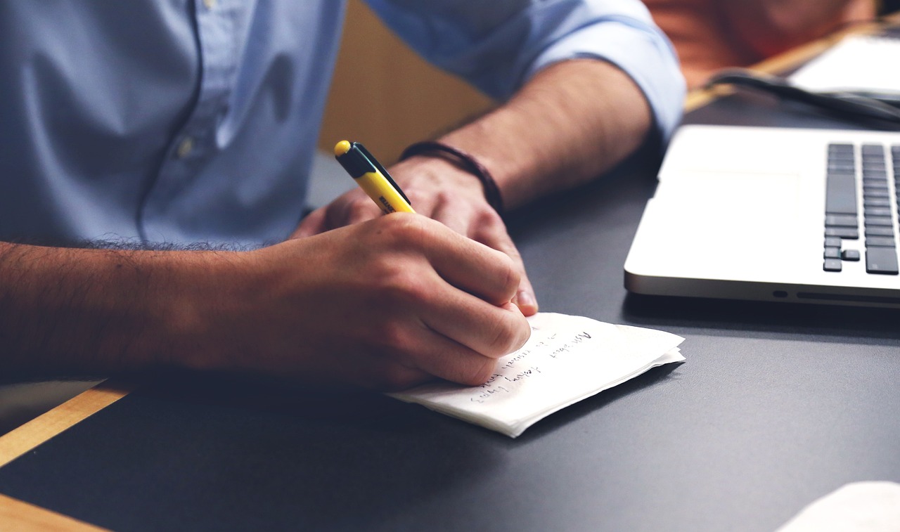 An open notebook with planning notes on a desk
