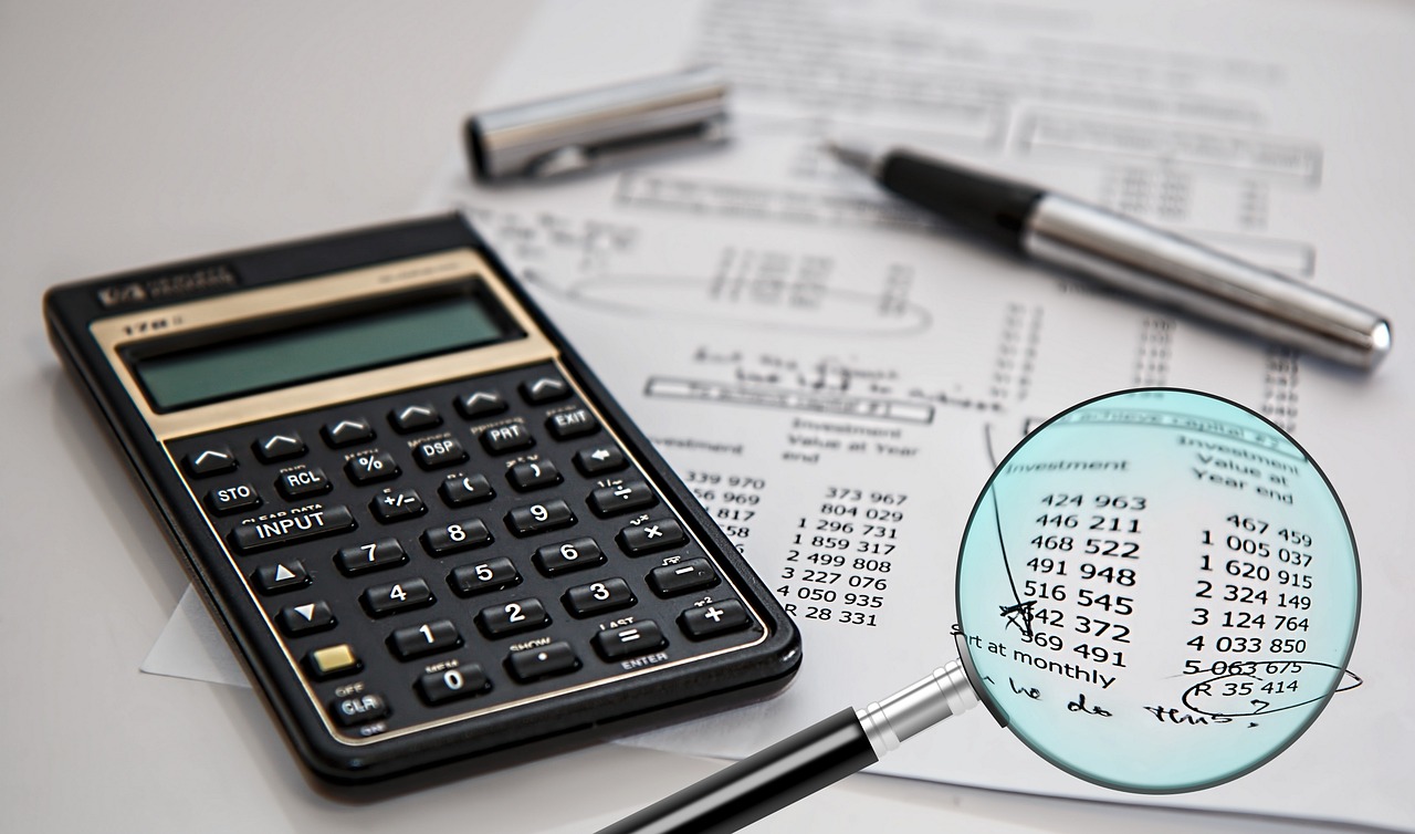 A magnifying glass over an audit report document