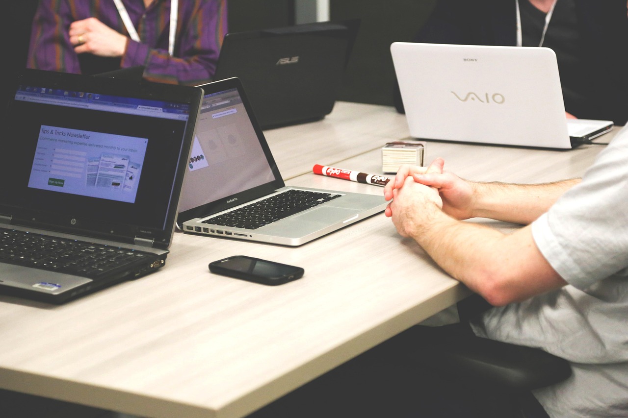A small startup team meeting around a laptop